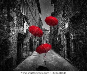 stock-photo-umbrellas-flying-with-wind-and-rain-on-dark-narrow-street-in-an-old-italian-town-i...jpg