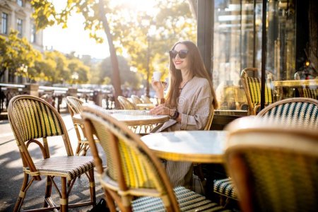 portrait-young-woman-enjoying-coffee-sitting-outdoors-traditional-french-cafe-morning-paris-wo...jpg