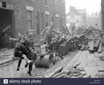 ww2-children-playing-games-children-make-a-see-saw-out-of-an-upturned-B3P4AB.jpg