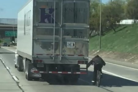 Cyclist-clings-to-back-of-truck-on-California-highway.jpg