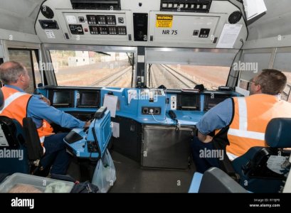 two-train-drivers-at-the-controls-in-the-cab-of-the-leading-locomotive-of-the-ghan-train-at-ka...jpg