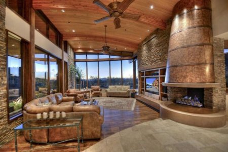 luxury-rustic-living-room-with-brown-leather-furniture-and-curved-ceiling-custom-copper-firepl...jpg