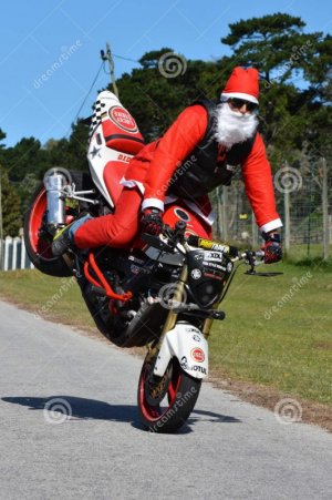 father-christmas-doing-front-wheel-wheelie-long-white-beard-red-motorbike-having-fun-72867780.jpg