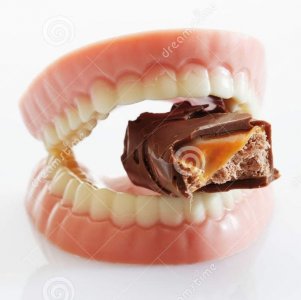 dentures-made-sugar-white-chocolate-biting-chocolate-bar-background-close-up-57993383.jpg