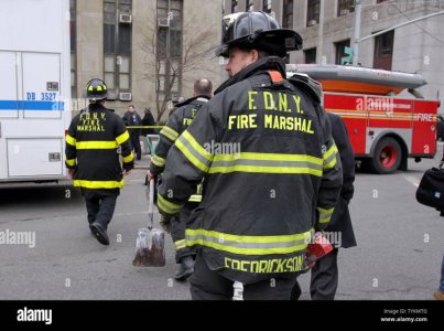 fire-marshals-enter-a-building-after-a-fire-broke-out-in-the-basement-of-the-manhattan-crimina...jpg