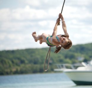 girl-on-rope-swing-over-the-water-picture-id104231540-1046829631.jpg