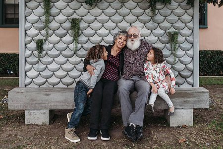 portrait-of-grandparents-sitting-with-cute-twin-grandchildren-outside-cavan-images.jpg
