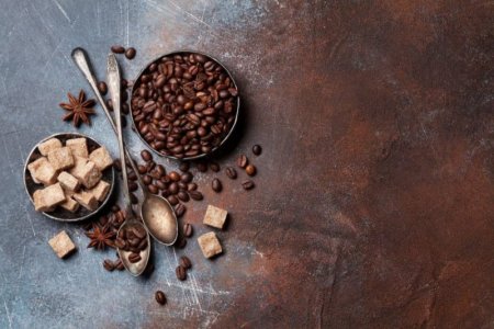 coffee-beans-and-sugar-cubes-on-brown-background-842x562.jpg