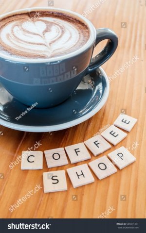 stock-photo-mocha-espresso-drink-from-local-coffee-shop-on-wooden-counter-with-coffee-shop-sig...jpg