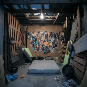 a-photo-of-a-makeshift-shelter-built-using-found-m-sbOhNnHhTFi6IzObGm71WA-a1B-wkXTQBSuSRMYfbS...jpeg
