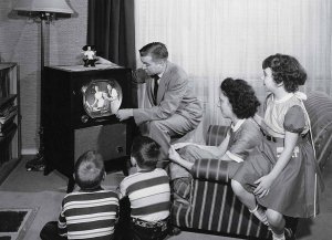 parents-with-three-children-watching-television.jpg