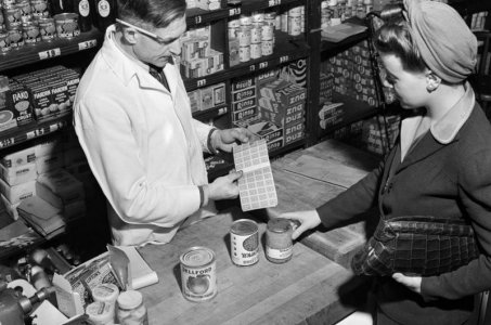woman buying goods with a ration book in New York, a common practice during WWII.jpg