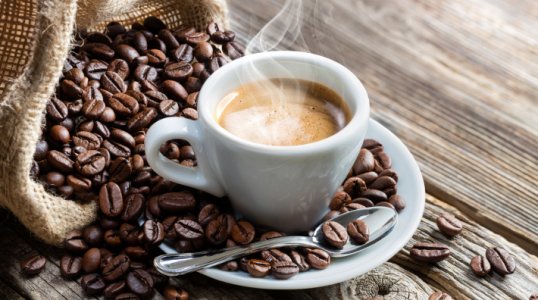 espresso-coffee-cup-with-beans-on-table-restricted-2422458648.jpg