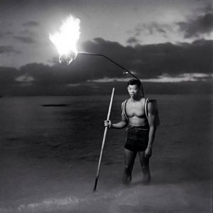 1948, this image shows a Hawaiian fisherman holding a torch made from kukui nuts.jpg