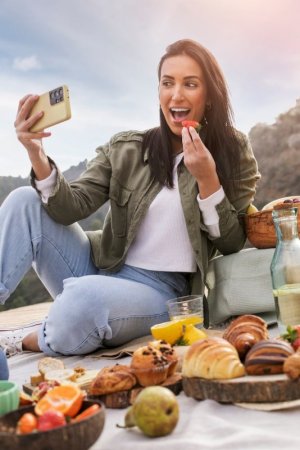 full-shot-smiley-woman-taking-selfie-while-eating_23-2149333804.jpg