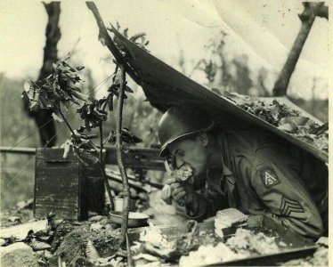 U.S. Sgt. Frank Shiborski eats a turkey leg on Thanksgiving in Italy, 1944..jpg