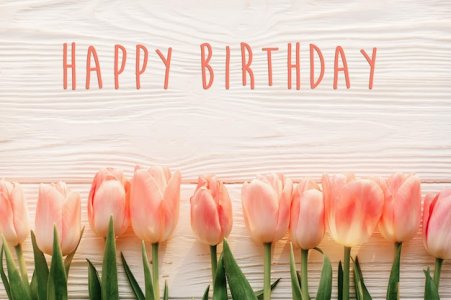 happy-birthday-text-sign-pink-tulips-white-rustic-wooden-background-flat-lay-spring-top-view-f...jpg