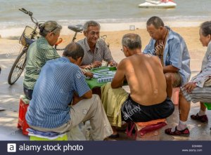 some-old-people-playing-mahjong-on-the-summer-beach-E0H48H.jpg