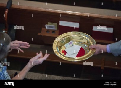 the-offering-plate-is-passed-down-a-pew-during-service-at-saint-martins-CYGC9J.jpg the-offering-plate-is-passed-down-a-pew-during-service-at-saint-martins-CYGC9J.jpg
