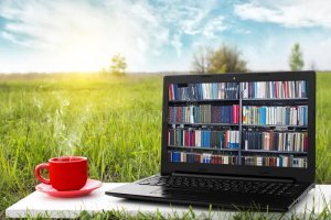 laptop-cup-hot-coffee-background-picturesque-nature-outdoor-office-e-book-library-concept-inte...jpg