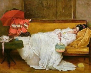 girl in a white dress resting on a sofa.jpg