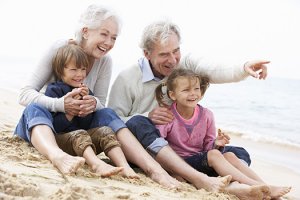 Grandparents-and-Grandchildren-Sitting-on-Beach-Together.jpg