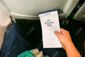 109886782-passenger-holding-air-sickness-vomit-bag-in-airplane-for-emergency.jpg